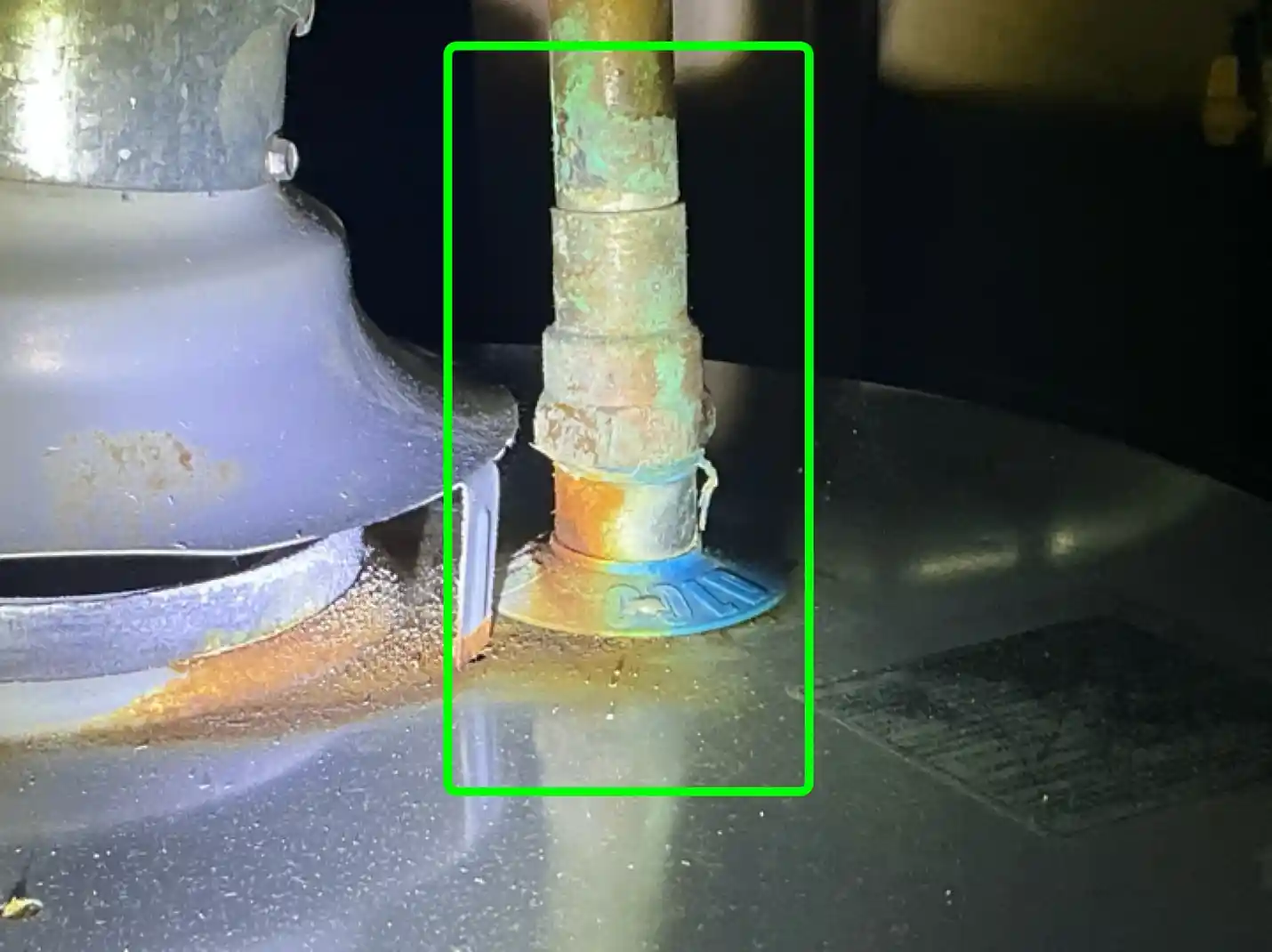 The home inspection highlights Corroded pipe at water heater in Brunswick found during the home inspection.