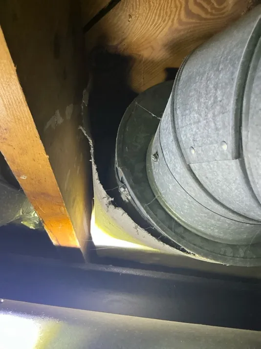 Peeling asbestos on HVAC duct in Brunswick was observed during a home inspection.