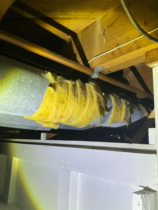 Exposed fiberglass insulation in the basement in Copley was found during a home inspection.