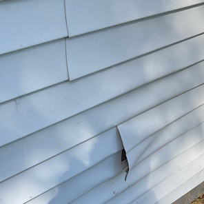 Damaged exterior siding on home in Beachwood.