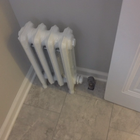 Disconnected heating radiator unit in a freshly remodeled home in Shaker Heights.